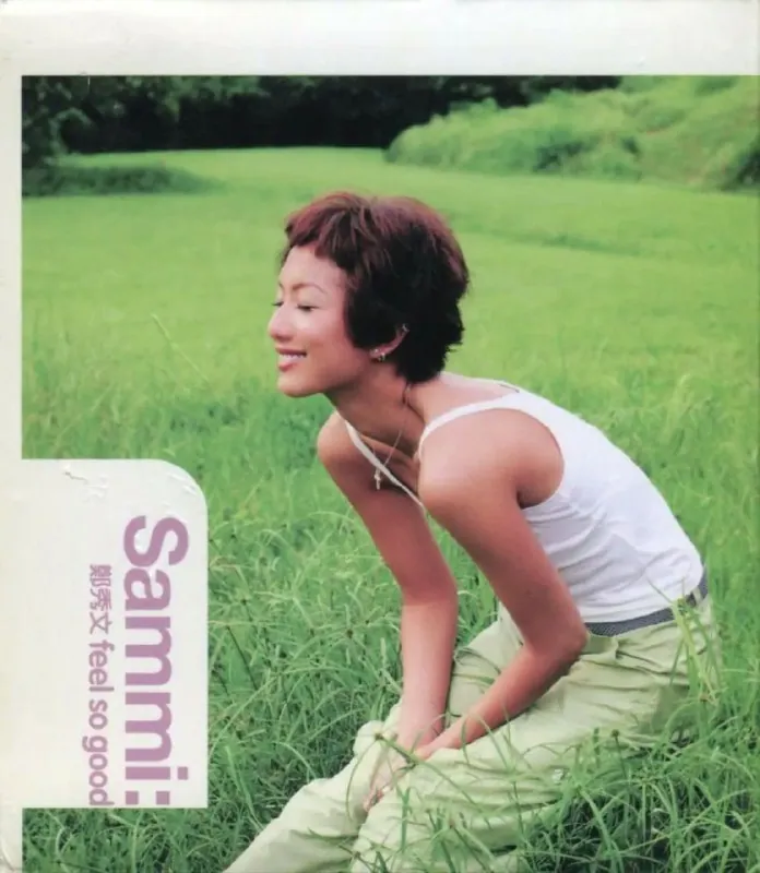 郑秀文1998香港版Feel So Good专辑封面，红发造型手持复古话筒，背景霓虹灯闪烁